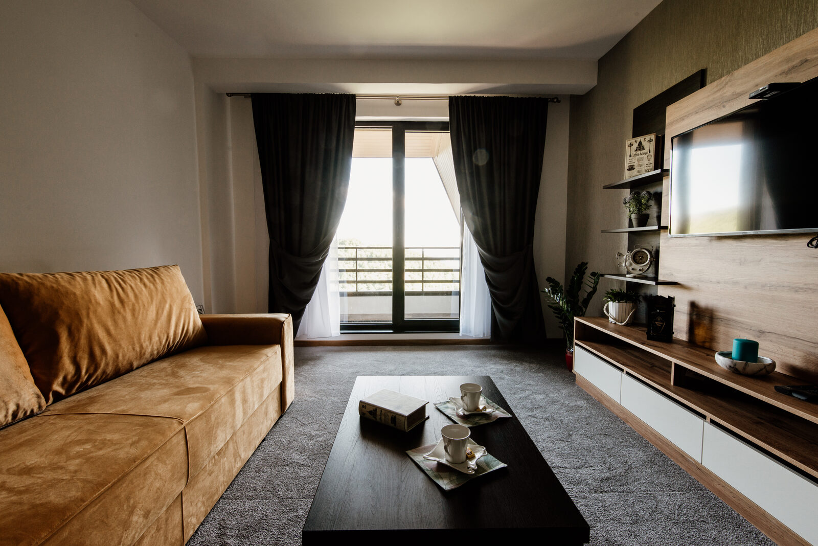 Living room with sofa, coffee table and wooden TV unit