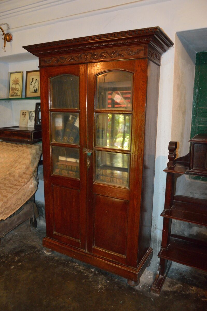 Traditional solid wood cabinet with carved detailing and glass doors