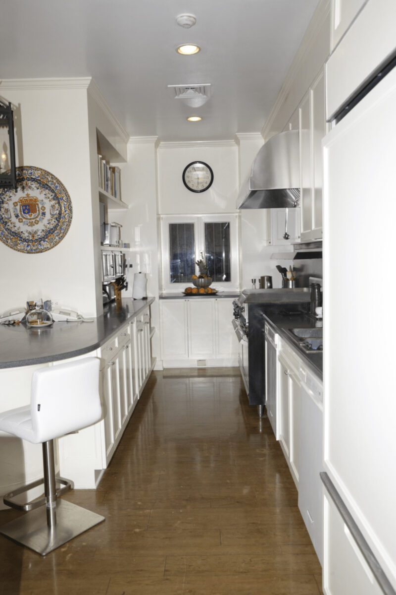 Modern white kitchen cabinets with dark countertop